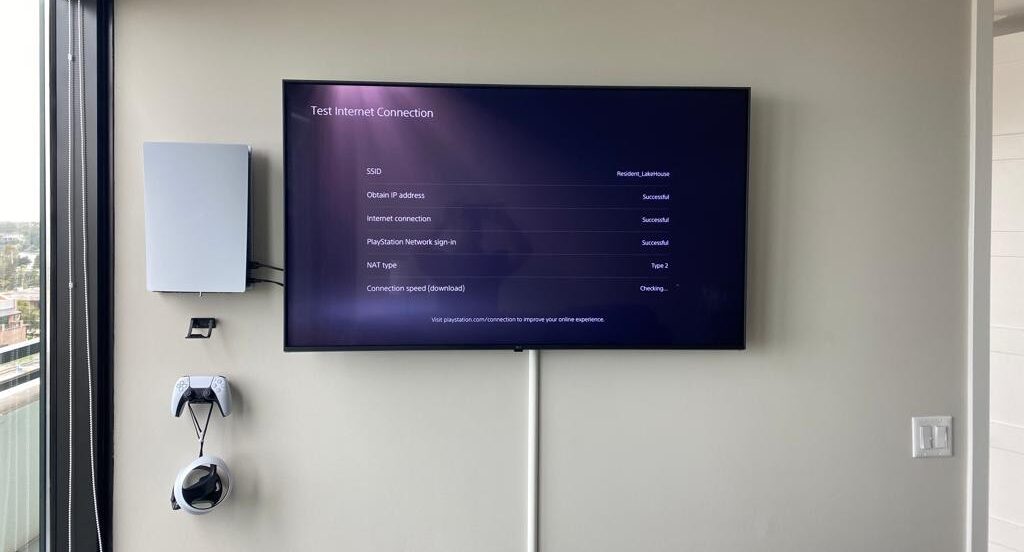 Tv mounted with gaming console and headsets