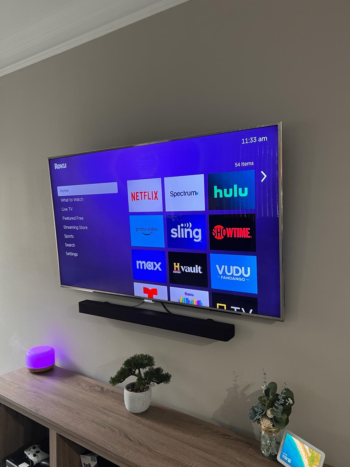 Pro services tech installed a tv on a tilt mount with a soundbar install and a power bridge