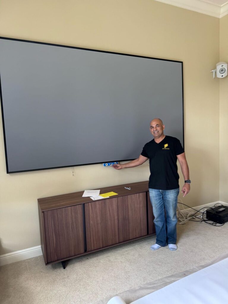 Pro Services Tech installed a huge projector screen and is showing that it is level