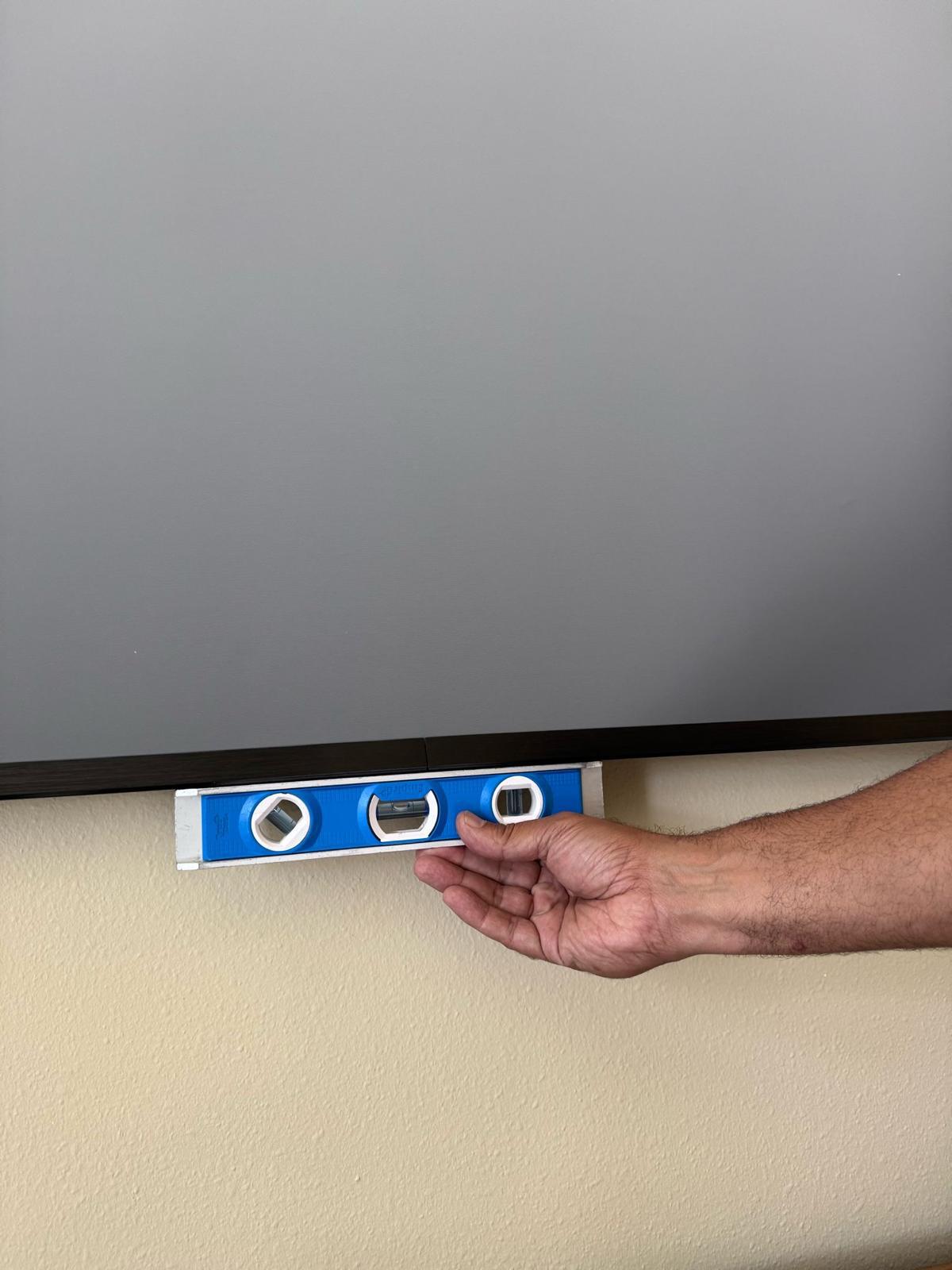 Pro Services Tech installed a huge projector screen and is showing that it is level